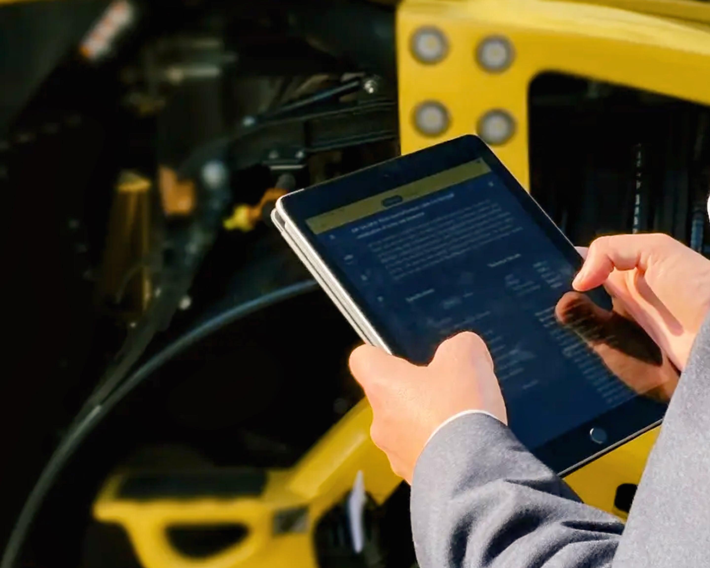 Person using App in front of BOMAG machine